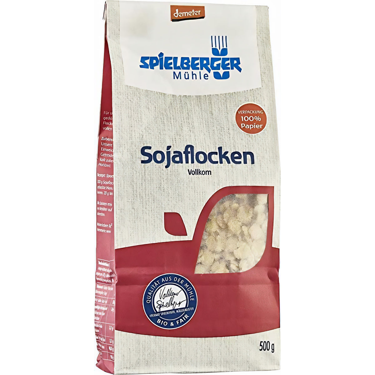 spielberger sojaflocken demeter 500g Packung leicht seitlich fotografiert, Sicht auf die Verpackung mit Sichtfenster und Produktinformationen, geeignet zum backen und kochen.
