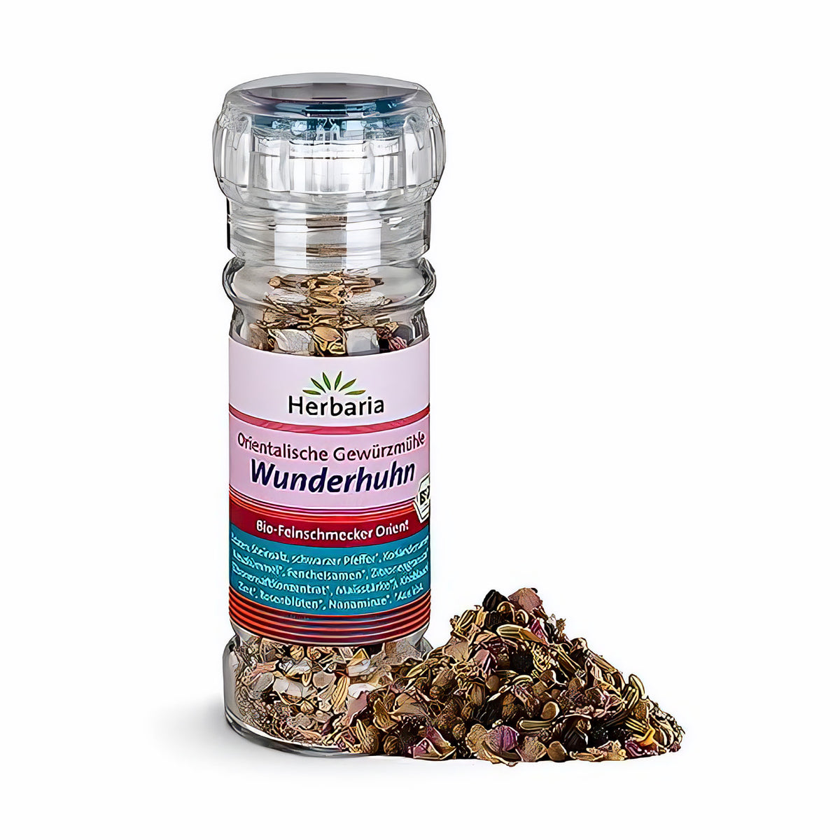 Herbaria Wunderhuhn Gewürzmühle mit orientalischer Gewürzmischung, Glas mit Streuer und daneben ausgeschüttetes Gewürz auf weißem Hintergrund.