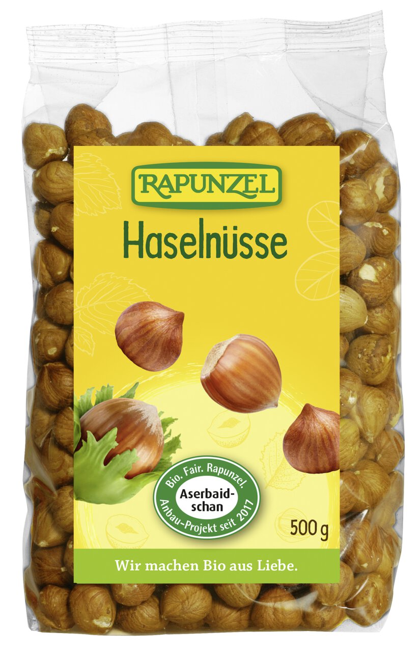 Bio Haselnüsse von Rapunzel, 500g, zum Kochen, in einer transparenten Schüssel sichtbar, mit braunen Nüssen und Schale.