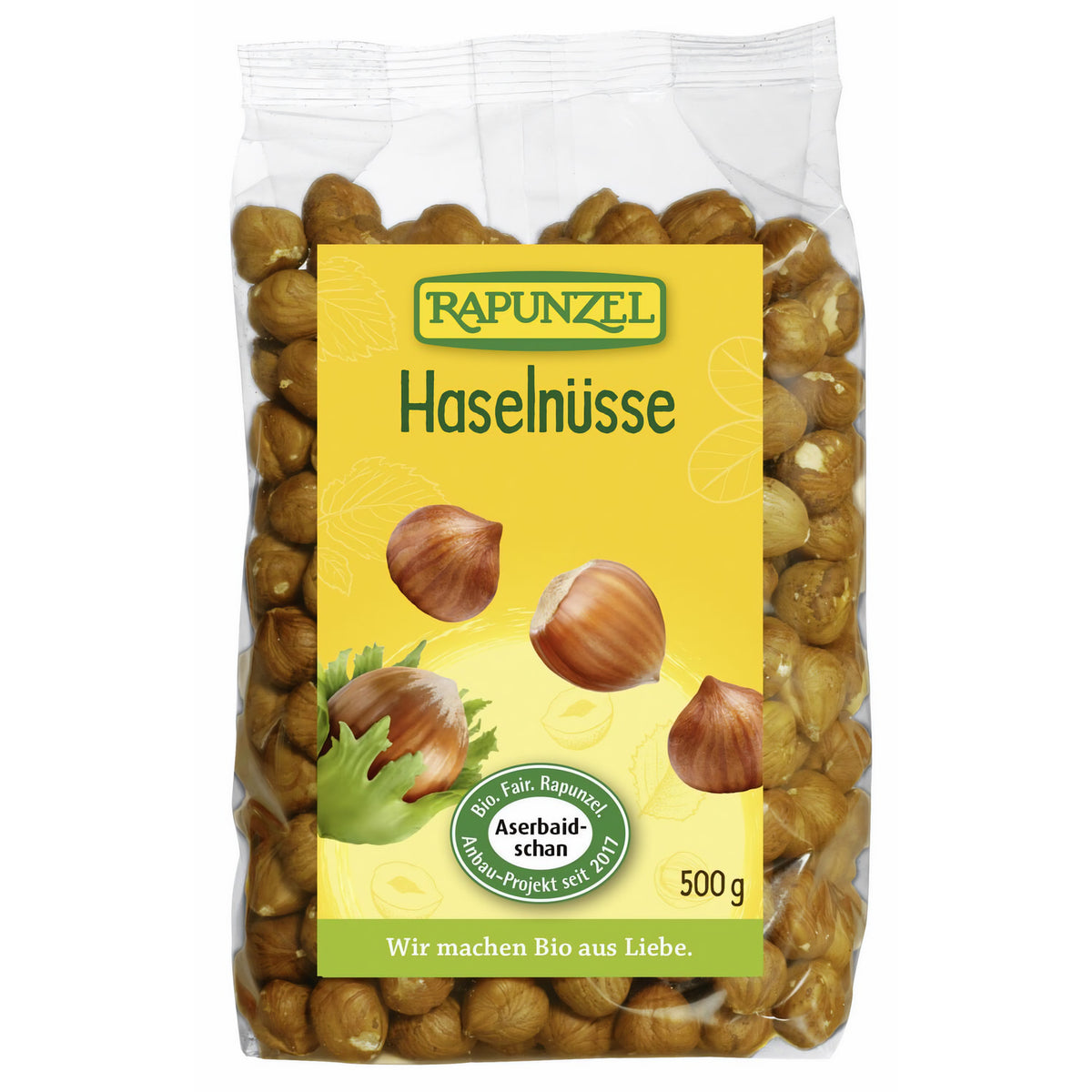 Bio Haselnüsse von Rapunzel, 500g, zum Kochen, in einer transparenten Schüssel sichtbar, mit braunen Nüssen und Schale.