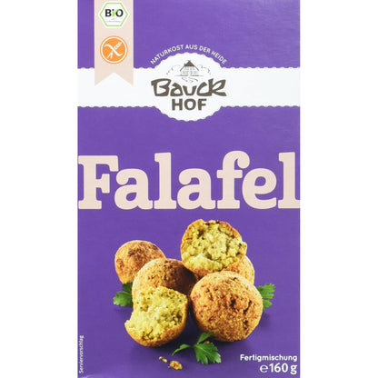 Vorderseite der Bauckhof Falafel Mischung glutenfrei, lila Verpackung mit Abbildungen von Falafel-Bällchen und Petersilie.