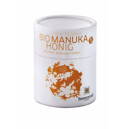 Weiße Dose Sonnentor starke Manukahonig 250g mit goldener Illustration und Produktaufschrift vor weißem Hintergrund.