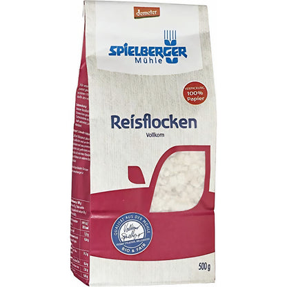 Spielberger Reisflocken demeter 500 g, seitlich fotografierte Packung auf weißem Hintergrund, Vorder- und Seitenansicht mit Produktinformationen.