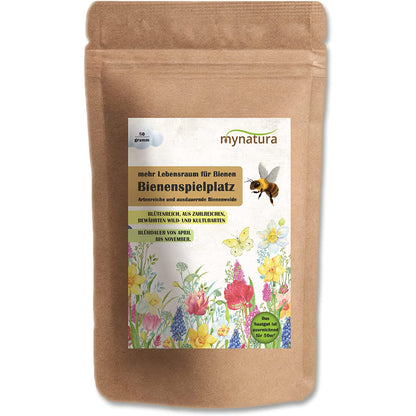 Braune Tüte Mynatura Bienenspielplatz Bienenweide 50g mit bunter Blumenwiese und Biene auf dem Etikett, geeignet für garten oder wiesenfläche.