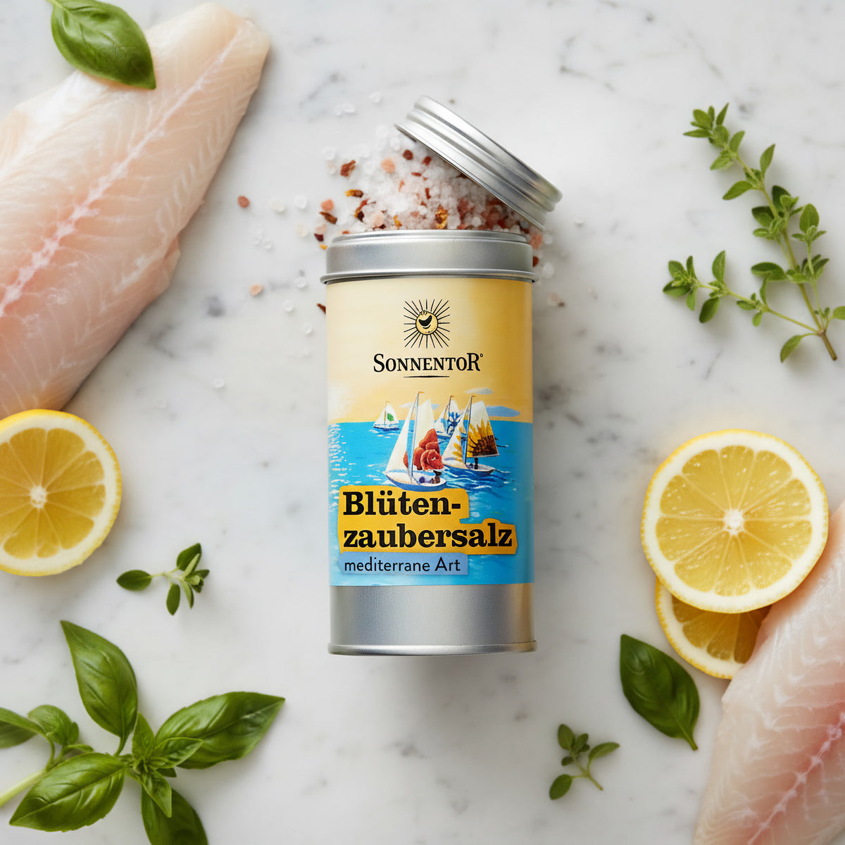 Create a cinematic overhead shot of the 'Blütenzaubersalz' on a pristine white marble countertop, styled next to fresh ingredients like fillets of fish, lemon slices, and sprigs of basil and oregano. Employ professional HDR studio lighting with soft shadow