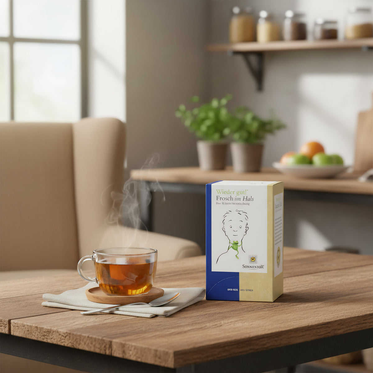 A lifestyle scene featuring the 'Sonnentor Frosch im Hals Bio-Kräutertee' box arranged on a rustic wooden table next to a cozy armchair. Natural diffused daylight pours in from a nearby window, illuminating the scene with a warm, inviting glow. A steaming 