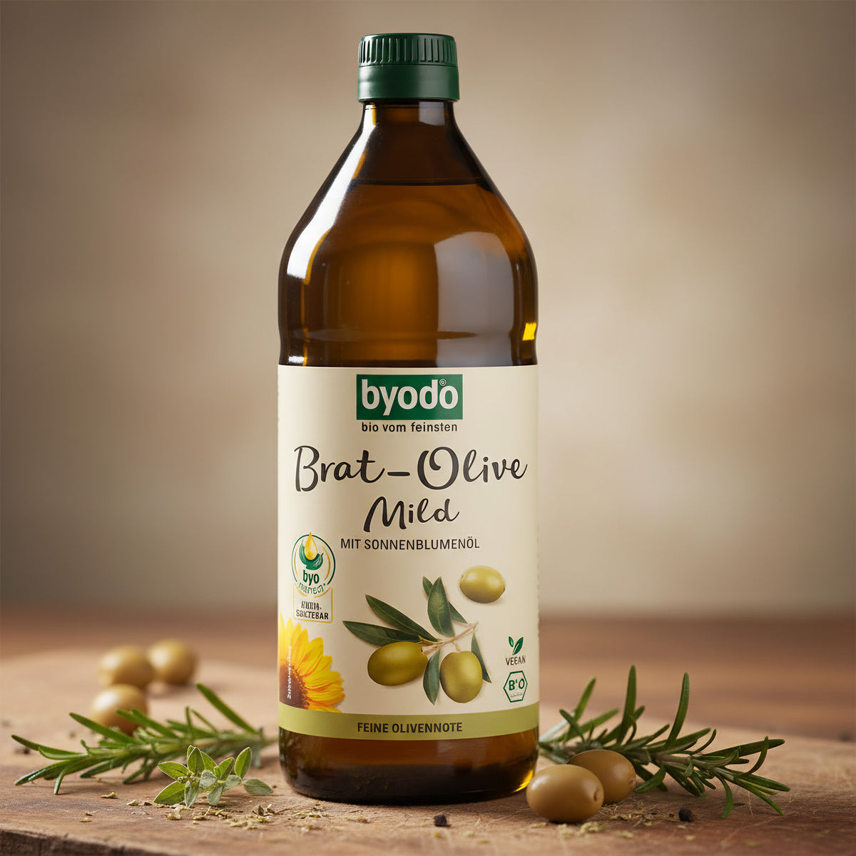 Elegant close-up of a 750ml BYODO Olive Mild oil bottle on rustic wooden surface, highlighting glass texture and golden hue with Mediterranean herbs.