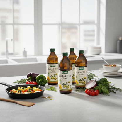 Stylish kitchen countertop scene with multiple BYODO Olive Mild bottles, fresh ingredients, and sizzling pan under natural light, showcasing culinary versatility.