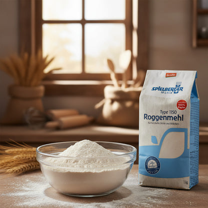 Close-up of a glass bowl filled with fine, powdery rye flour, illuminated by natural sunlight in a rustic kitchen setting, highlighting purity and quality.