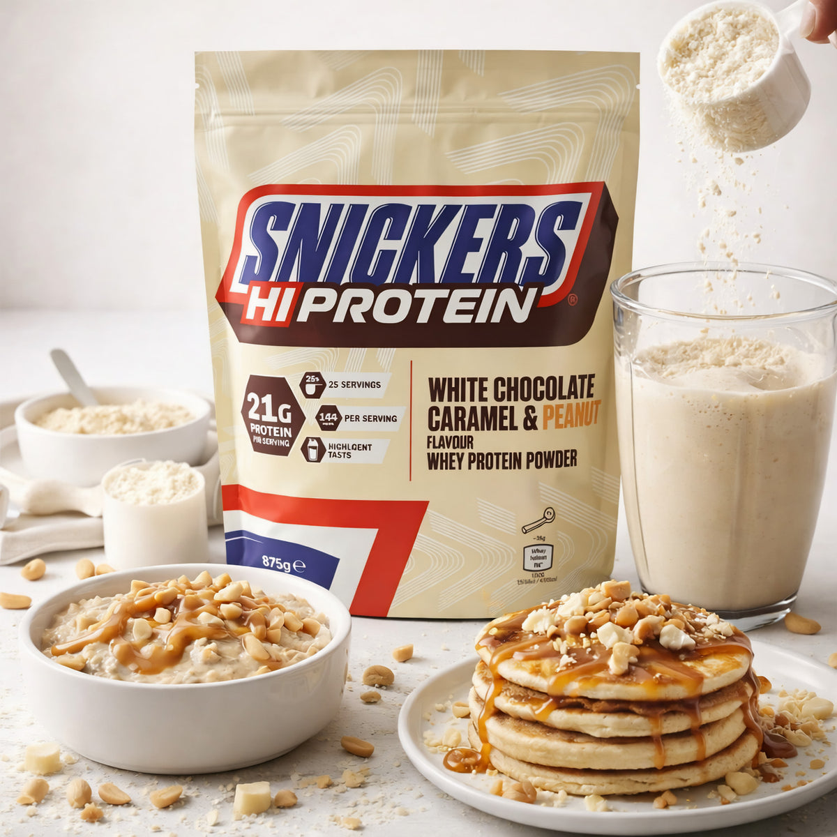 Snickers Protein Shake Beutel mit Glas Shake, Pancakes und Porridge, dekoriert mit Nüssen und Karamell