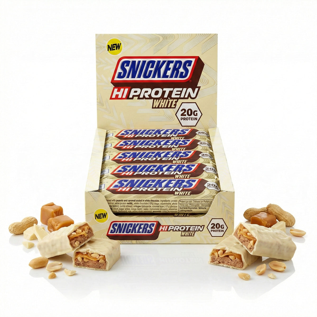 Snickers Hi-Protein White Bar 12x57g in geöffneter Verkaufspackung, vorne angeschnittene weiße schokoriegel mit sichtbaren Erdnüssen und Karamell, umgeben von Erdnüssen und Karamellstücken.