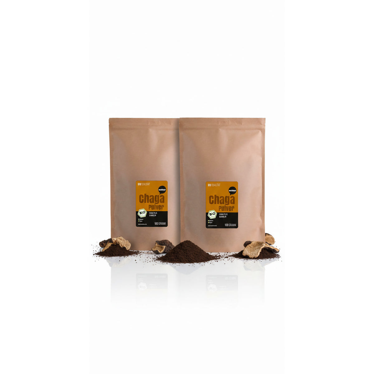 Zwei braune Beutel wohltuer Chaga Pulver 100g mit losem Pilzpulver und getrockneten Pilzstücken davor auf weißem Hintergrund.