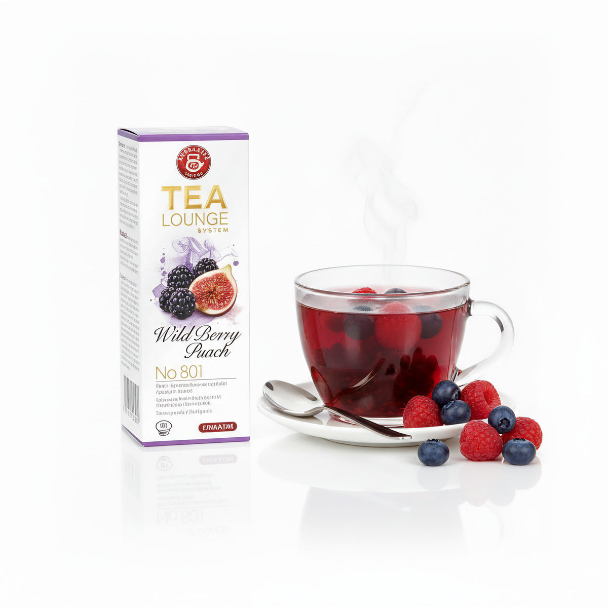 Teekanne Teelounge Wild Berry Pack mit dampfender Tasse Tee, frischen Beeren und Löffel auf Untertasse daneben.