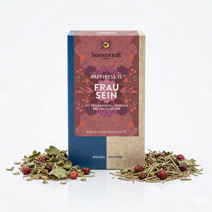Packung Sonnentor Frau sein Tee mit losem Kräutertee und Preiselbeeren auf weißem Hintergrund, Produkt und Zutaten im Vordergrund
