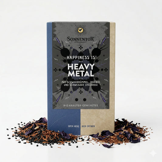 Packung Sonnentor Heavy Metal Kräutertee mit losem Tee, Gewürzen und Blütenblättern auf weißem Untergrund.