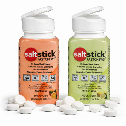 Zwei Dosen SaltStick Fast Chews Elektrolyt-Kautabletten in Orange- und Zitronen-Limetten-Geschmack mit geöffnetem Deckel und mehreren weißen Kautabletten davor.