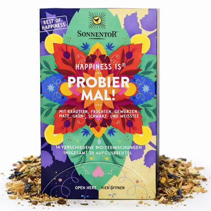 Sonnentor Bio-Tee Probier mal! Happiness, 32g, in einer offenen Teeverpackung mit Teeblättern und Kräutern.