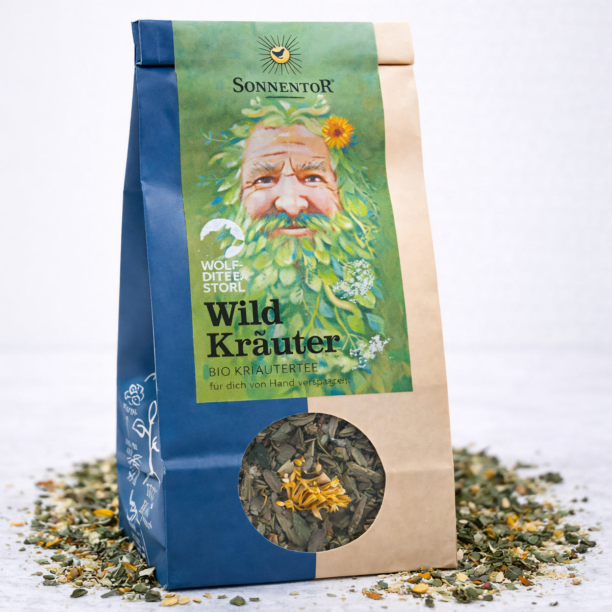 Bio Wildkräuter-Tee von Sonnentor, frisch und aromatisch, in einer 50g Verpackung, zeigt eine Tasse mit Kräutertee und Kräuter im Bild.