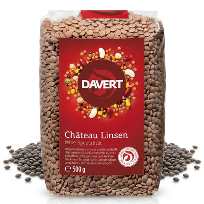 Packung Davert braune Tellerlinsen 500g mit rotem Etikett, umgeben von losen Linsen auf weißem Hintergrund.
