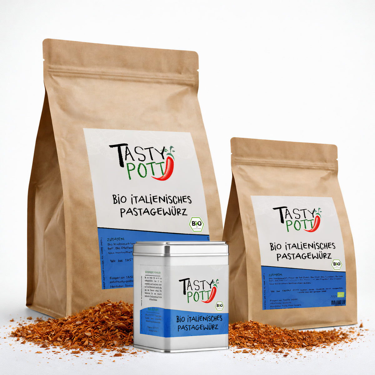 Drei Tasty Pott Beutel und eine Dose Bio italienisches Pastagewürz Gewürzmischung, stehend auf verstreuten mediterranen Kräutern.