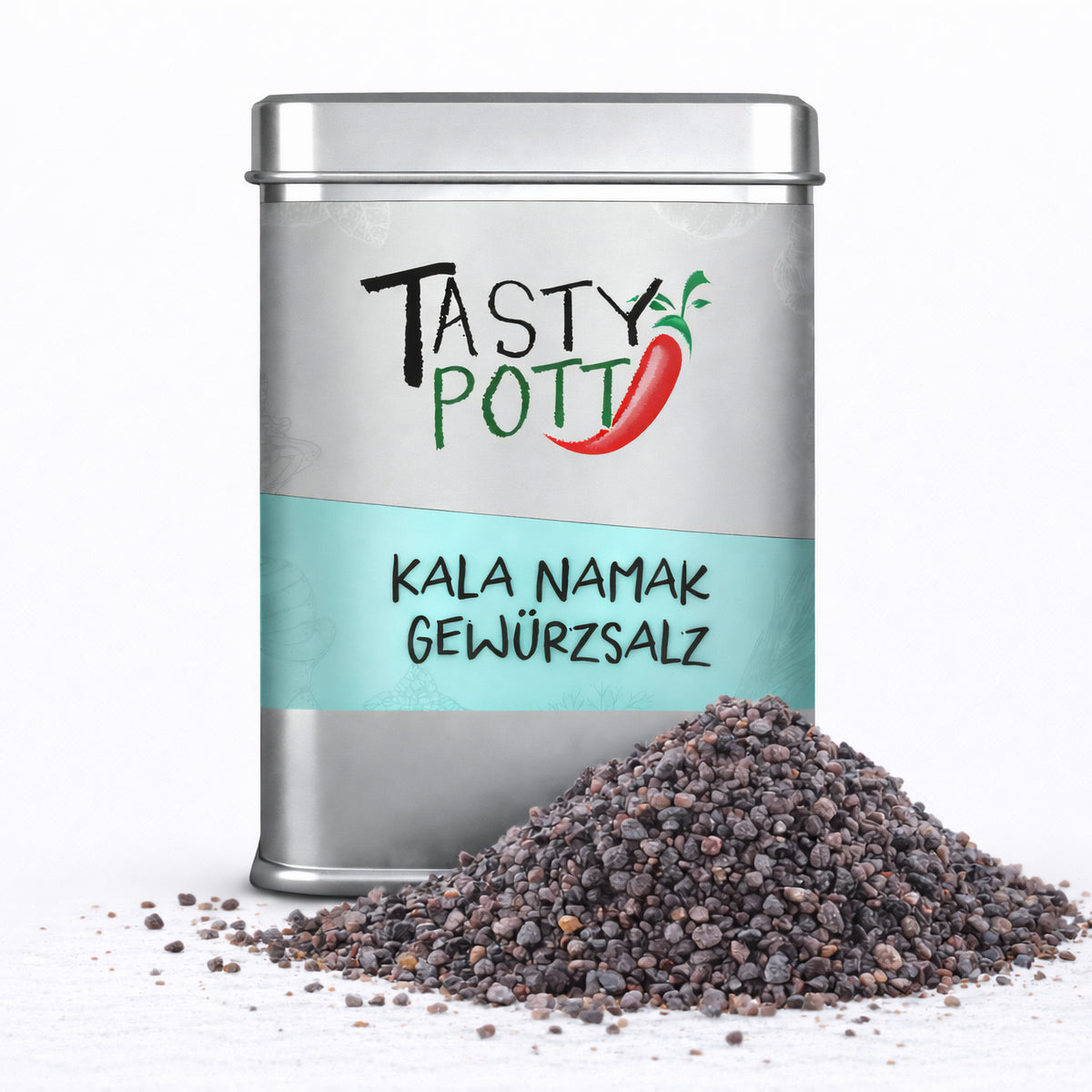 Tasty Pott Kala Namak Salz in silberner Dose mit türkisfarbenem Etikett, davor ein Haufen grobkörniges indisches Schwarzsalz auf weißem Untergrund.