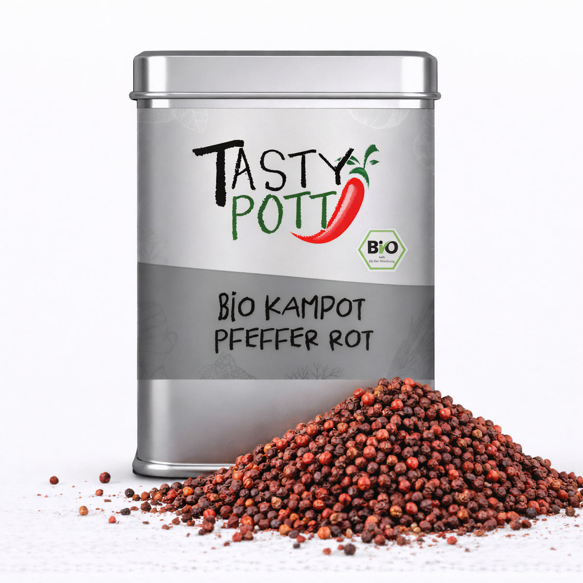 Vorderseite einer silbernen Tasty Pott Dose mit Aufschrift Bio Kampot Pfeffer rot, davor ein Haufen roter Pfefferkörner.