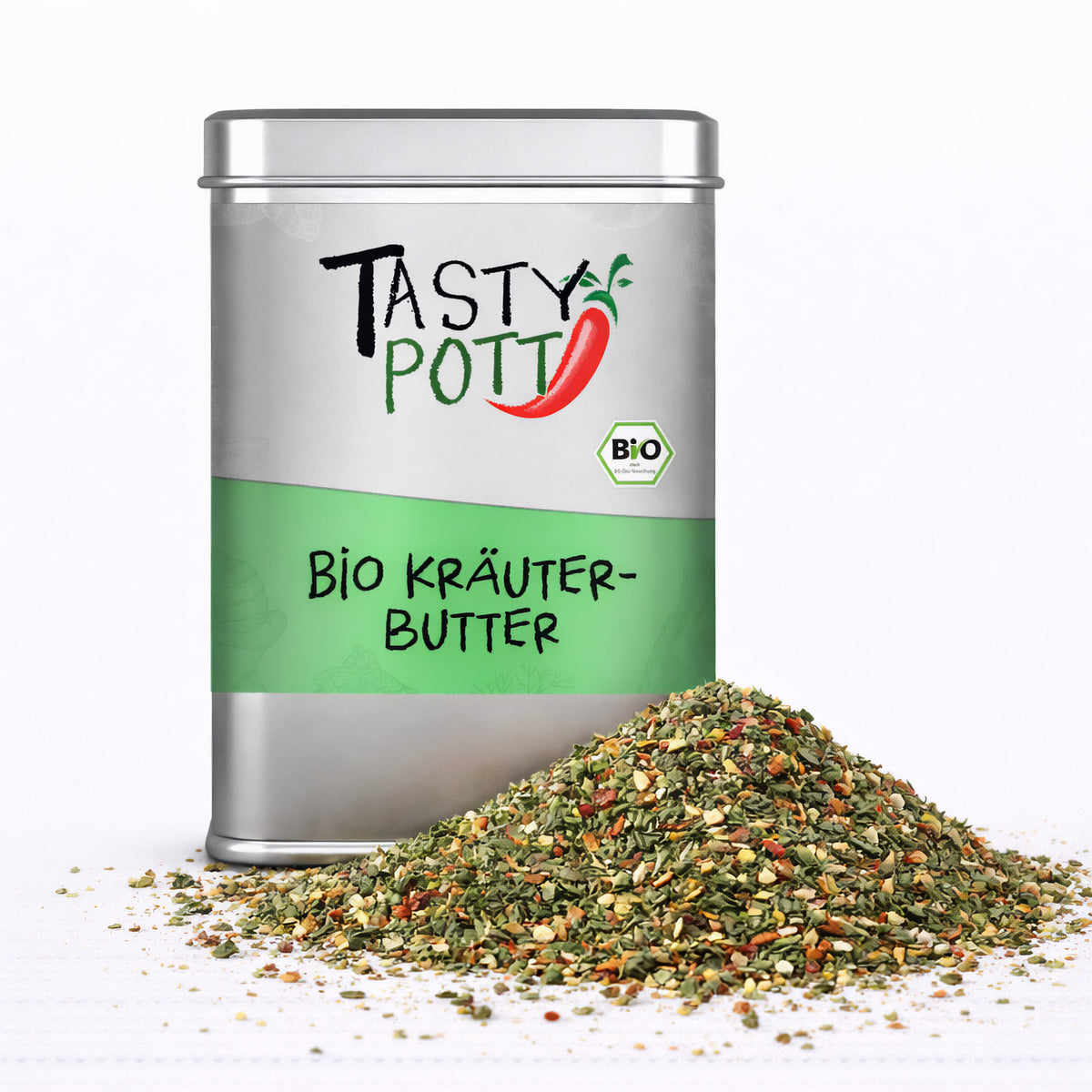 Tasty Pott Kräuterbutter Gewürzmischung in silberner Dose mit grünem Etikett, davor ein Haufen bunter Kräuter und Gewürze auf weißem Untergrund.