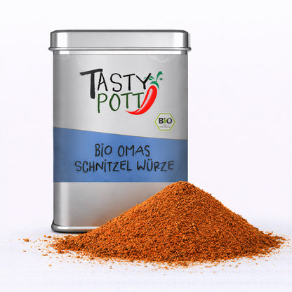 Tasty Pott Bio Omas Schnitzel Würze 100g Dose mit einem Haufen der roten Gewürzmischung im Vordergrund auf weißem Untergrund.
