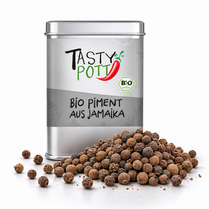 Tasty Pott Bio Piment ganz in silberner Dose, davor ein Haufen ganzer Pimentkörner auf weißem Untergrund.