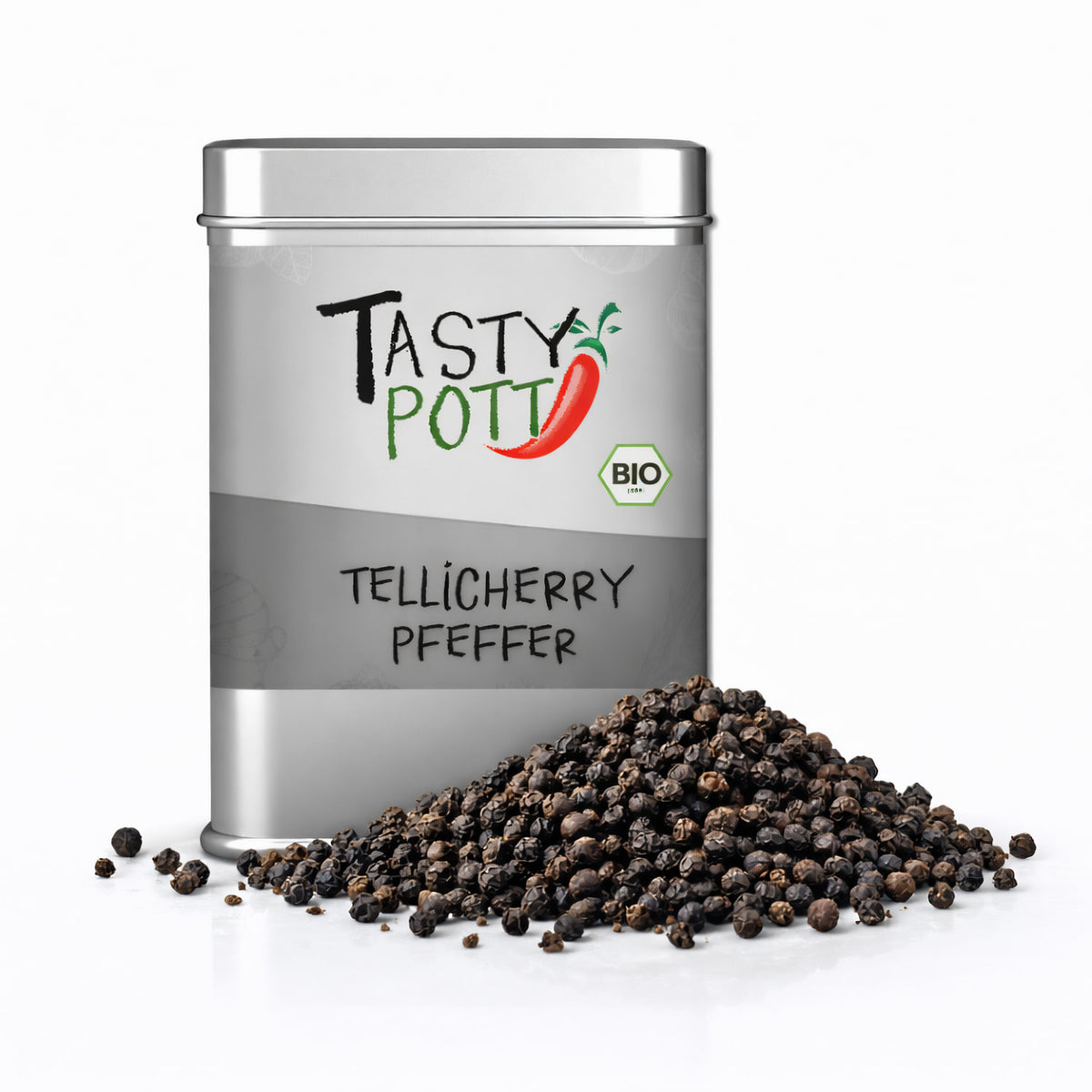 Tasty Pott Tellicherry Pfeffer ganz in silberner Dose, davor ein Haufen ganzer schwarzer Pfefferkörner auf weißem Untergrund.