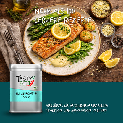Tasty Pott Zitronensalz Dose vor einem Teller mit gebratenem Lachs, grünem Spargel, Kartoffeln und Zitronenscheiben.