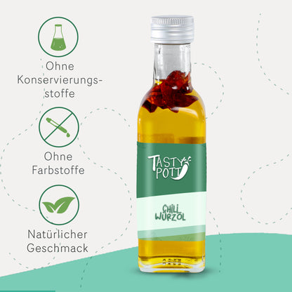Tasty Pott Chili Würzöl 100ml Flasche mit sichtbaren Chilistücken, daneben Symbole für natürliche Zutaten und ohne Farbstoffe, auf hellem Hintergrund.