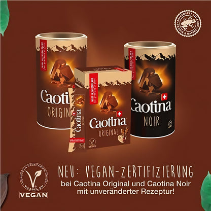 Caotina Noir und Original Trinkschokolade 450g als Dosen und Portionssticks nebeneinander aufgestellt