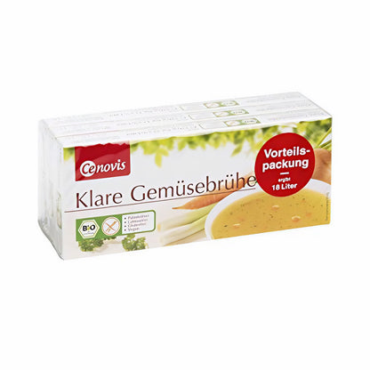 Cenovis Gemüsebrühe Vorteilspackung als Brühwürfel, schräg von vorne fotografiert, Suppenteller und Gemüse sichtbar.