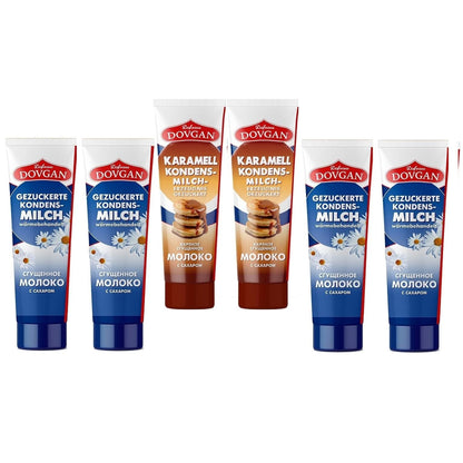 Sortiment Dovgan gezuckerte Kondensmilch in Tube, vier blaue Tuben traditionelle Milch und zwei braune Tuben Karamell, alle Tuben stehend frontal sichtbar.
