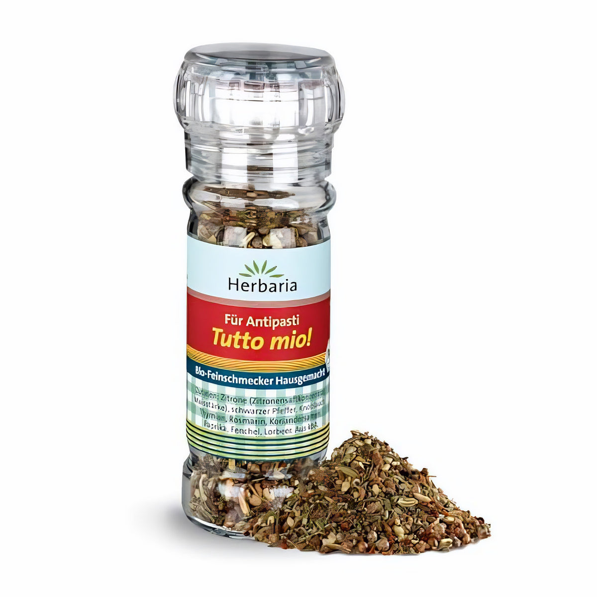 Herbaria Tutto mio! Bio-Gewürzmischung in transparenter Mühle mit mediterranen Kräutern, daneben ein kleiner Haufen der groben Gewürzmischung für Antipasti.