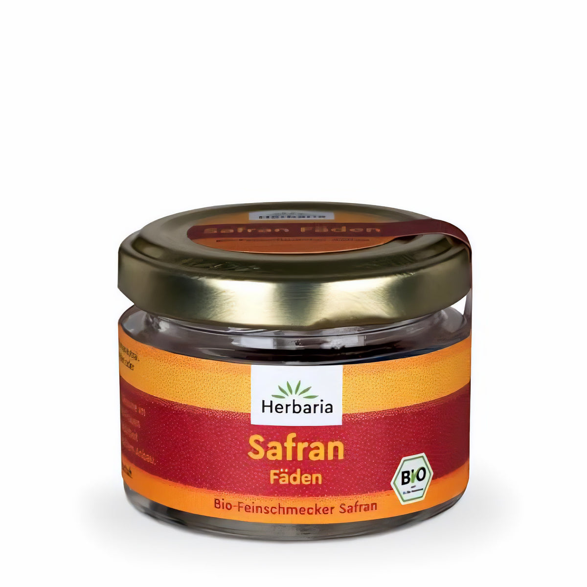 Herbaria Safran-Fäden im kleinen Glas mit goldfarbenem Schraubdeckel und orangem Etikett, das Gewürz ist im Glas sichtbar.