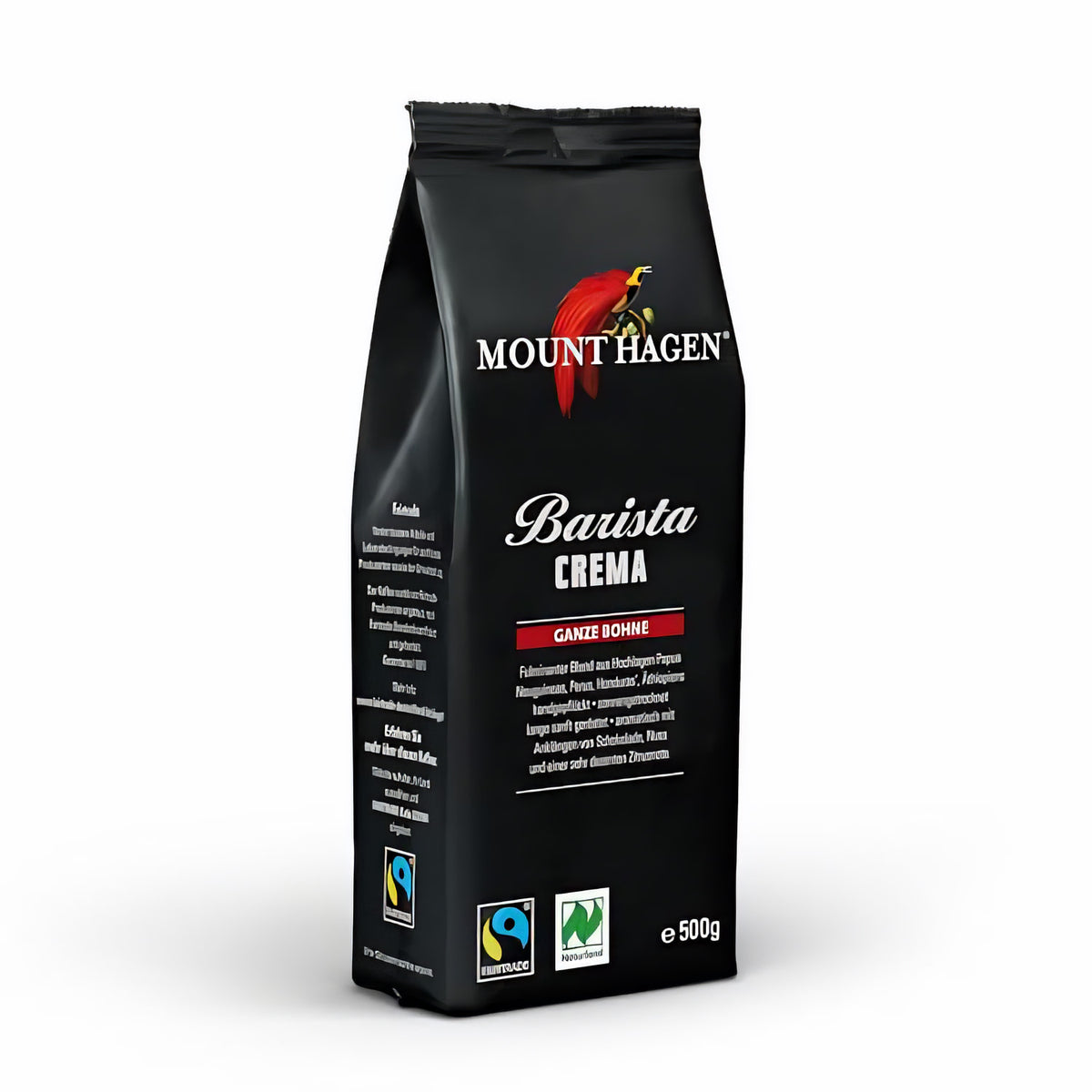 Packung Mount Hagen Barista Crema ganze Bohne 500g mit Fairtrade- und Naturland-Siegel, stehend auf weißem Hintergrund.