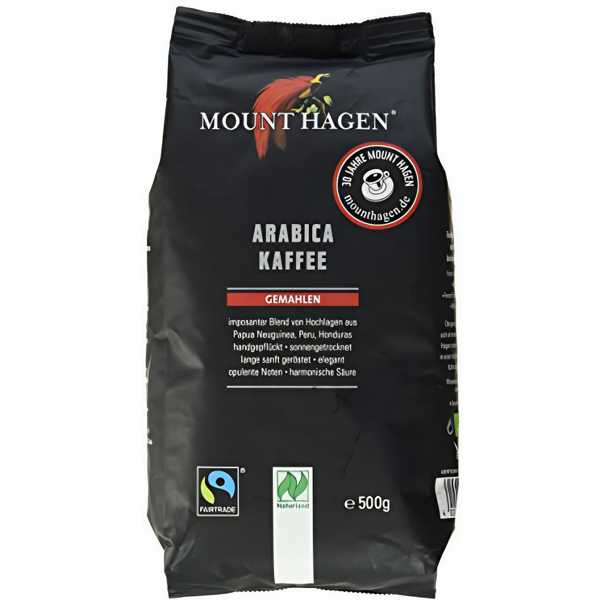 Vorderseite einer schwarzen Mount Hagen Arabica Kaffee 500g Packung mit Fairtrade- und Naturland-Logo, Aufschrift gemahlen und Produktbeschreibung.