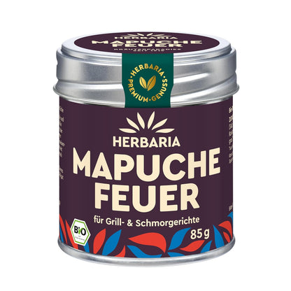 Herbaria Mapuche-Feuer Gewürzmischung in einer 85g Dose mit violettem Etikett und buntem Blättermuster, Produktname und Bio-Siegel gut sichtbar.